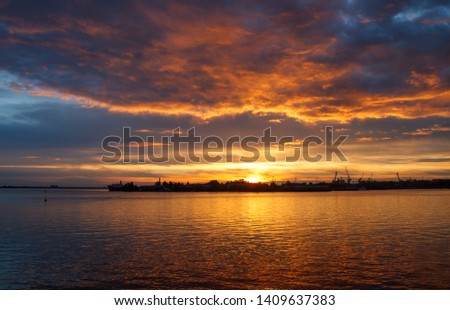 unusually bright sunset with dark clouds