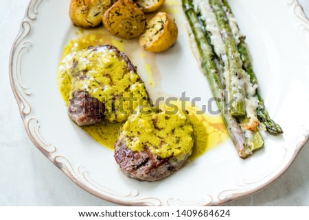Tenderloin Meat with Cafe De Paris Sauce with Asparagus and Baked Potatoes in Plate Ready to Serve.