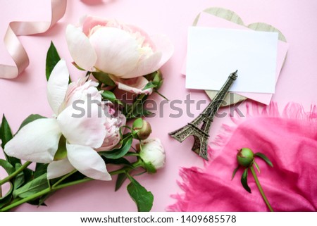 casket with a picture of the Eiffel Tower, pink peonies and an envelope. congratulation. invitation