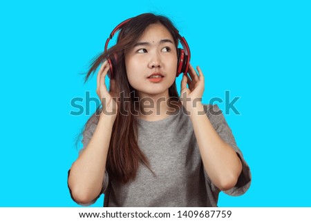 young woman wearing headset enjoying new audio tracks playing in 
smartphone.