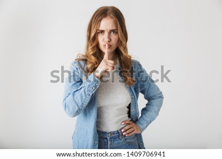 Image of a beautiful young pretty woman posing isolated over white wall background make silence gesture.
