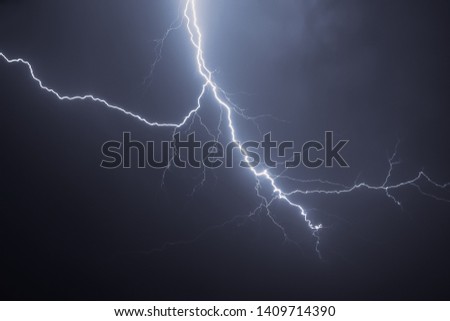 Bright lightning in the black sky over the city Royalty-Free Stock Photo #1409714390