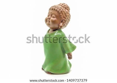 selective focus on chinese ceramic young monk doll isolated on white background