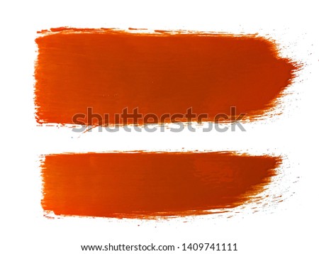 orange paint or ink brush strokes on white background 