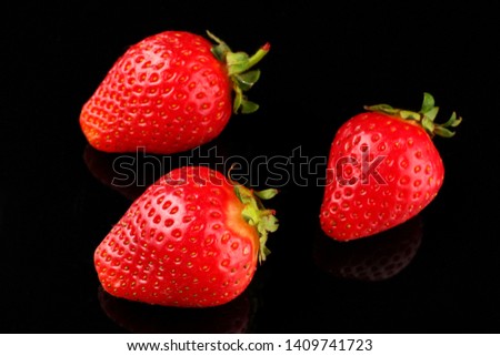 A few strawberries on a dark background