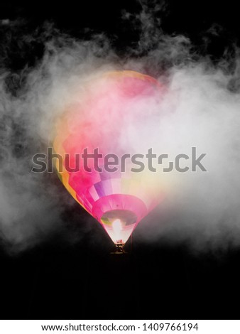 Big balloon in the night sky in the clouds