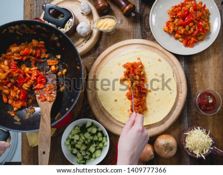 chopped vegetables and chicken cooking process burrito