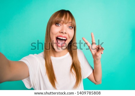 Close up photo cute pretty teen teenager make photos charming v-sign shout yell summer travel holidays weekend rest relax content enjoy fringe rejoice modern youth outfit isolated green background