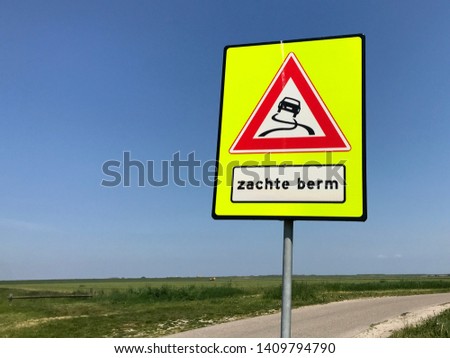 Dutch traffic road sign warning for a soft roadside (Dutch: zachte berm).