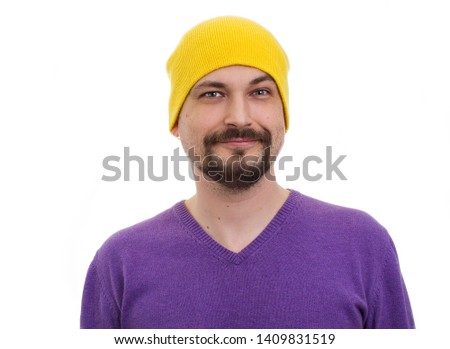 pleased with myself man in yellow hat and a purple sweater expressive make faces. humorous ironic funny male portrait on a white background.