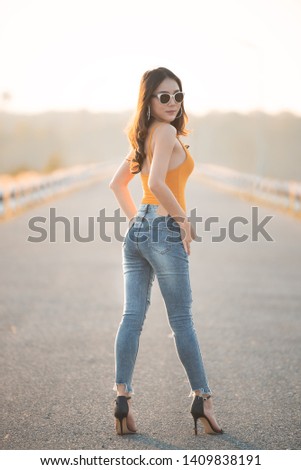 Portrait of beautiful asian woman at the field on sunset,Thailand people