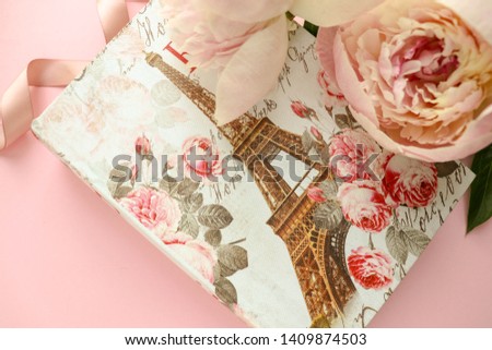 romantic concept. gift box with the image of the Eiffel Tower, pink peonies and an envelope