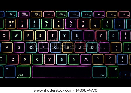 Colourful light laptop / notebook / PC keyboard isolated on black background