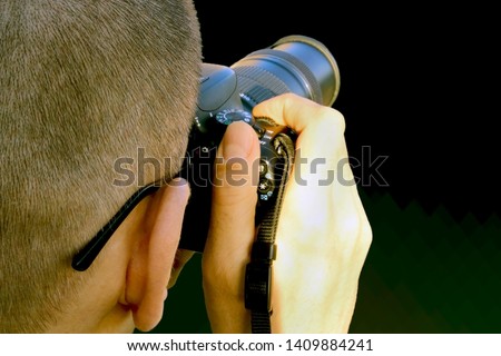 Man taking photo with camera from behind