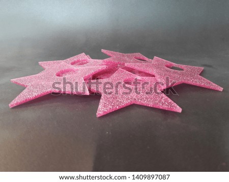 pink star, made of acrylic on black background