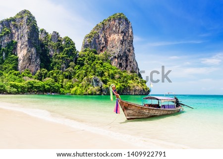 Thai traditional wooden longtail boat and beautiful sand Railay Beach in Krabi province. Ao Nang, Thailand. Royalty-Free Stock Photo #1409922791