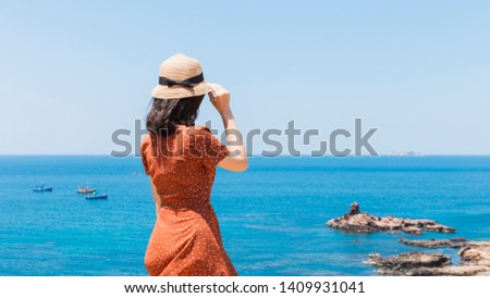 The girl on the blue sea background