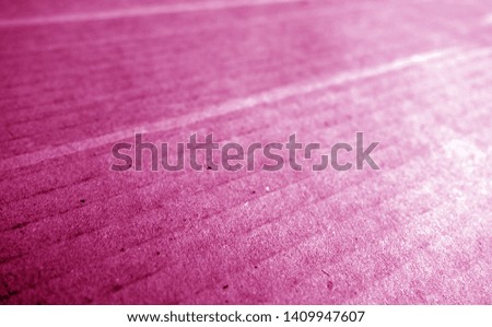 Cardboard close-up with blur effect in pink tone. Abstract background and texture for design.