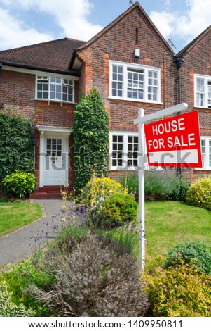 House for sale sign outside a typical UK semi-detached house in London