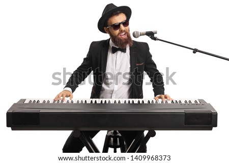 Man with sunglasses and a beard playing a digital piano and singing on a microphone isolated on white background
