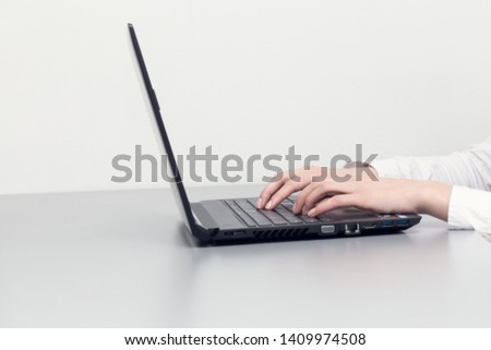Woman's hands are writing on a laptop. Work concept on a computer. Natural and minimalistic photography.