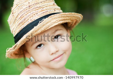A girl in a straw hat in the park
