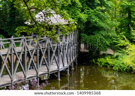Beautiful bridge over water in amazing garden.