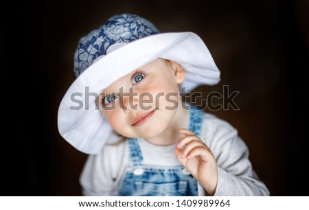 Little child baby smiling. Baby in a hat.