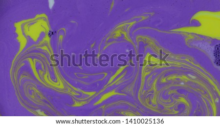 Abstract psychedelic background. Ink in a multicolored liquid. Colorful paint drops mixing in water. River of liquid. Colorful paint