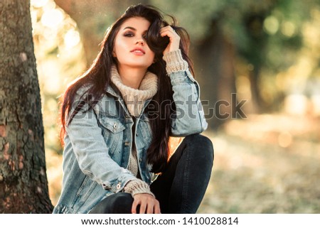 Beautiful model posing for the camera in the park.