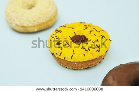Delicious donuts on light pastel color background. National Donut Day concept.