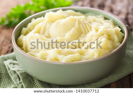 Fresh homemade creamy mashed potato in bowl (Selective Focus, Focus one third into the potato puree) Royalty-Free Stock Photo #1410037712