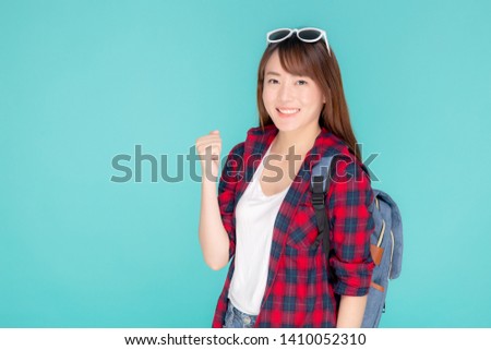 Beautiful portrait young asian woman wear sunglasses on head smile confident and excited summer holiday isolated blue background, model girl fashion having backpack, travel concept.