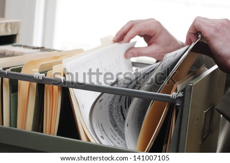 Paperwork in a filing cabinet Royalty-Free Stock Photo #141007105