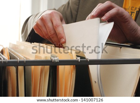 Paperwork in a filing cabinet Royalty-Free Stock Photo #141007126