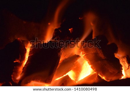 The flame burns the charcoal in the stove causing heat and lighting.