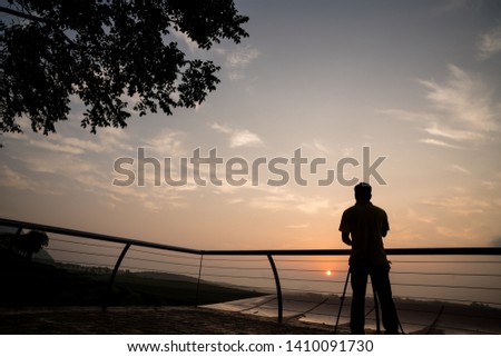 silhouette of photographer take photo at sunset 