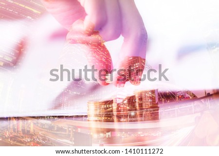Double exposure,saving money concept, preset by femmale hand putting money coin stack growing business on the table work in the office with filter effects background