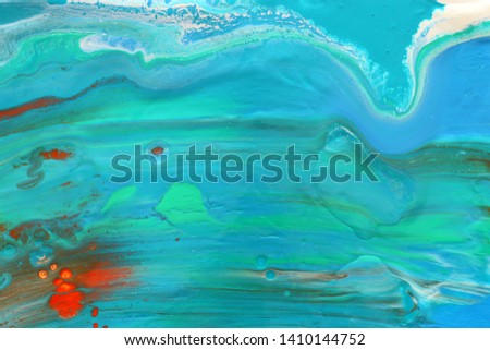 photography of abstract marbleized effect background. Blue, mint and white creative colors. Beautiful paint with the addition of gold