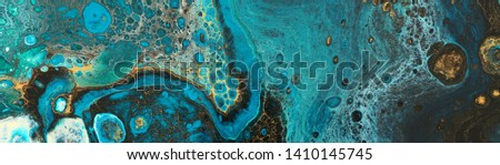 photography of abstract marbleized effect background. Blue creative colors. Beautiful paint with the addition of gold