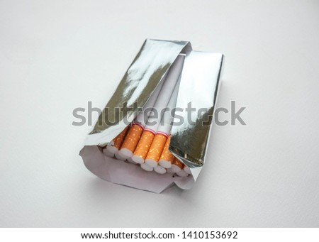 World No Tobacco Day; Open pack of cigarette tobacco in foil isolated on white background.