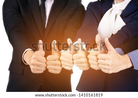 A group of male and female businessmen commented on their approval and approval by showing thumbs. (Congratulations concept)