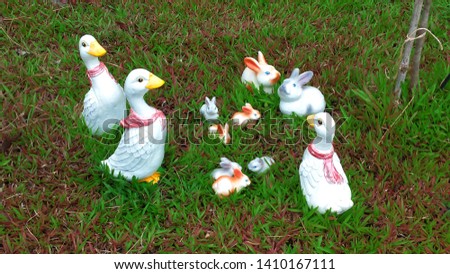 rabbit and duck on the green grass