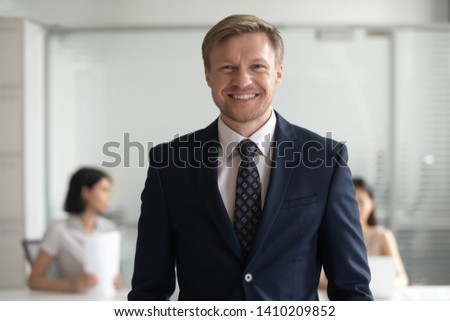 Confident smiling middle aged business man ceo banker coach in suit looking at camera, male company director owner professional manager posing in office, happy team leader employer head shot portrait Royalty-Free Stock Photo #1410209852