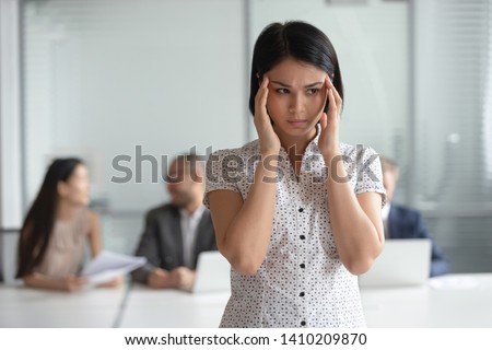 Stressed nervous asian business woman employee feel headache at work, frustrated tired anxious japanese female executive suffer from migraine overwork dizziness at workplace massage temples in office Royalty-Free Stock Photo #1410209870