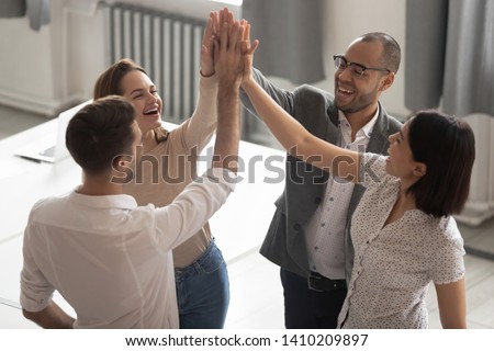 Happy motivated diverse business work team people employees group giving high five together engaged in teambuilding celebrate success good teamwork result shared win promise trust integrity concept Royalty-Free Stock Photo #1410209897