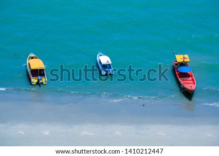 top view colorful speed boats near the beach with blue sea and fine sand, tropical summer in Thailand
