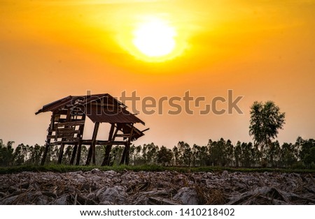 Old little hut in the fields under the beautiful sky before the sun sets,image