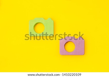 Blogger concept with photo camera on yellow background top view mockup