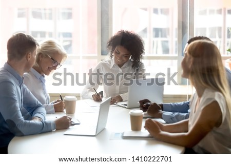 Signing contracts for services at group negotiations concept, diverse businesswomen seller and client company representatives partners making sale purchase business deal agreement at team meeting Royalty-Free Stock Photo #1410222701